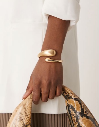 cuff bracelet with wrap around molten detail with shiny and brushed gold tone