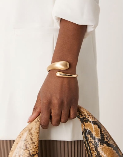 cuff bracelet with wrap around molten detail with shiny and brushed gold tone