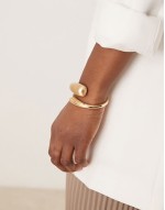 cuff bracelet with wrap around molten detail with shiny and brushed gold tone